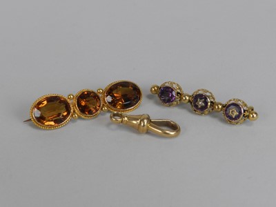 Lot 141 - A three stone citrine set bar brooch