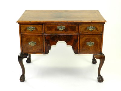 Lot 453 - An early 18th century walnut veneered lowboy,...