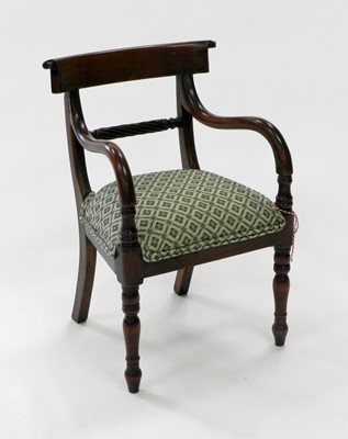 Lot 509 - An upholstered mahogany child's open armchair.