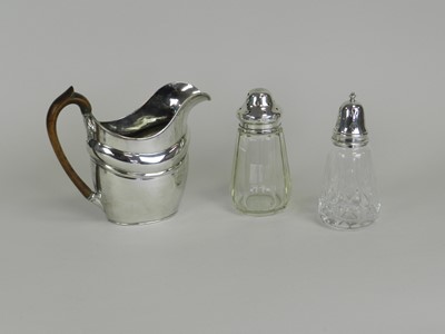 Lot 30 - A silver plated jug and two silver mounted glass sugar casters