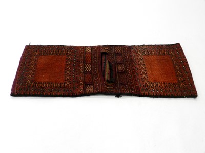 Lot 548 - A Near Eastern woven wool camel saddlebag,...