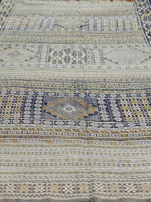 Lot 551 - A Near Eastern geometric woven wool carpet,...