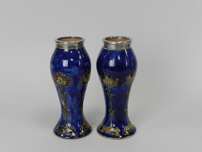 Lot 261 - A pair of Royal Doulton vases with silver mounted rims