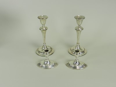 Lot 81 - Two pairs of silver mounted candlesticks