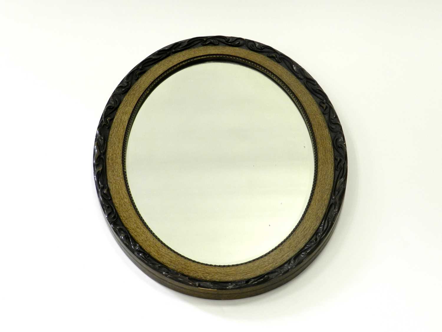 Lot 481 - An oval wall mirror with moulded frame and...