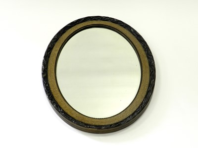 Lot 481 - An oval wall mirror with moulded frame and...