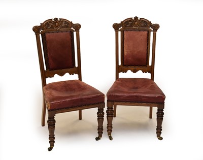 Lot 464 - A set of 8 carved oak Victorian dining chairs, with hide covered seats and backs