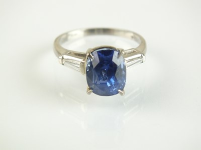 Lot 74 - A three stone sapphire and diamond ring