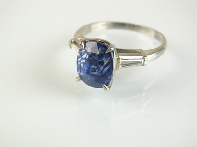 Lot 74 - A three stone sapphire and diamond ring