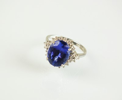 Lot 88 - An 18ct white gold tanzanite and diamond cluster ring