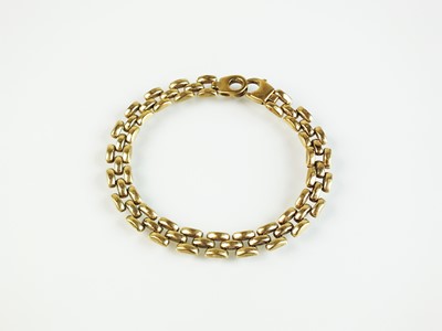 Lot 64 - A 9ct gold three bar brick link bracelet