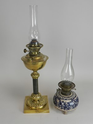 Lot 308 - A brass candlestick oil lamp and another...