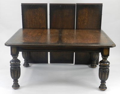 Lot 402 - An Edwardian oak dining suite comprising a...