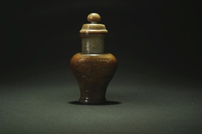 Lot 331 - A Chinese green and russet jade archaistic vase and cover
