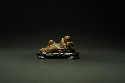 Lot 428 - A Chinese green and russet soapstone figure of a reclining Buddha and tiger