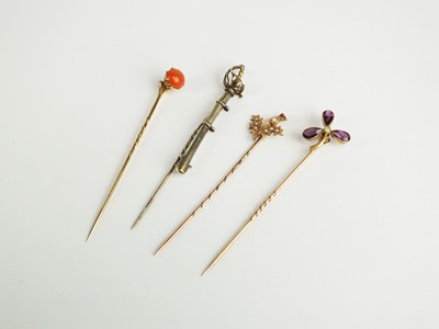 Lot 86 - A collection of four stick pins