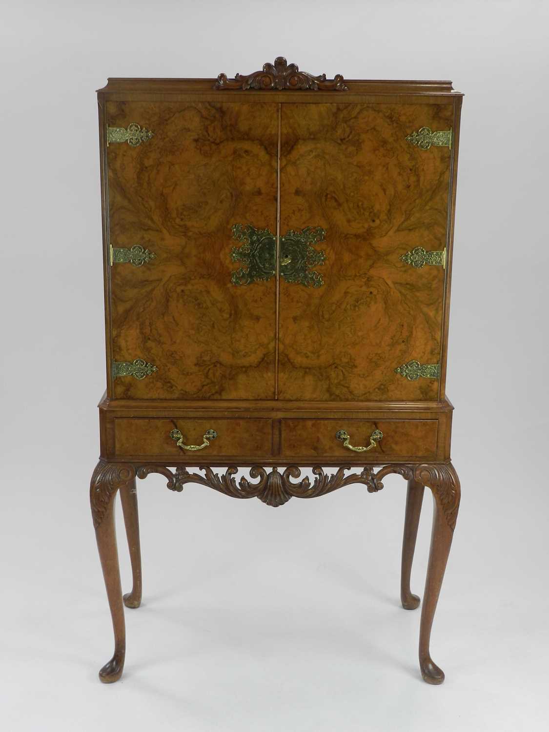 Lot 492 - A Queen Anne style walnut cocktail cabinet,...