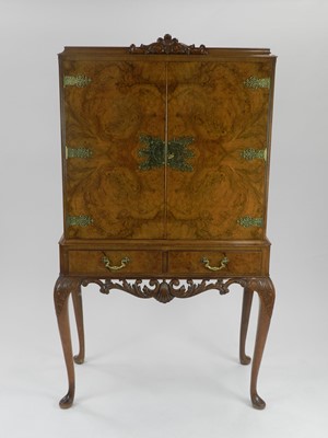 Lot 492 - A Queen Anne style walnut cocktail cabinet,...