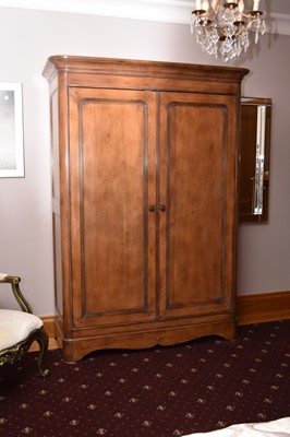 Lot 233 - A reproduction walnut double wardrobe, the...