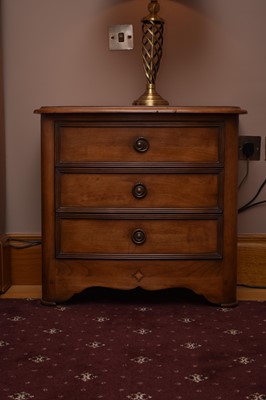 Lot 235 - A pair of reproduction walnut bedside chests...