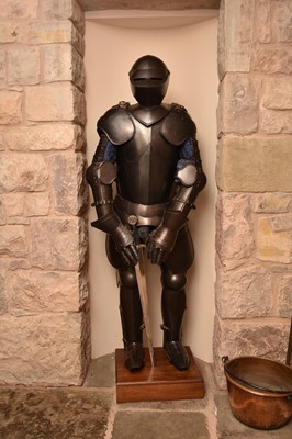 Lot 254 - A reproduction suit of armour, set on a wood...