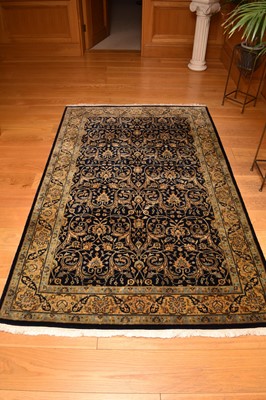 Lot 255 - A set of three graduated Indo-Persian rugs,...