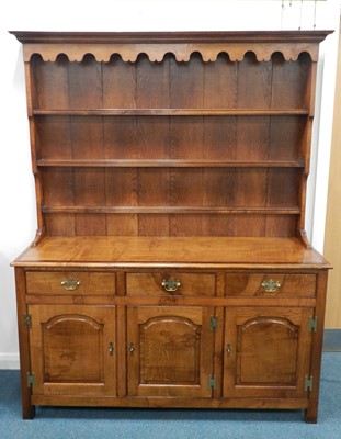 Lot 424 - A recent reproduction oak dresser and rack,...