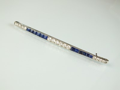 Lot 26 - An Art Deco diamond and sapphire bar brooch