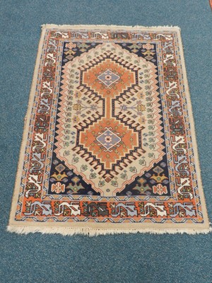 Lot 488 - Three Persian rugs, the first with three...