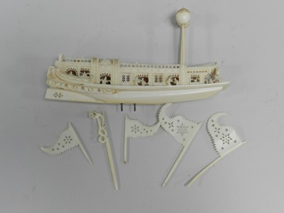 Lot 306 - Two Chinese carved ivory figures, two puzzle balls, one lacking majority of concentric balls, a double gourd being pulled by figures and a barge (6)