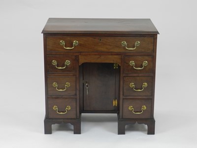 Lot 447 - A George III style mahogany kneehole desk, the...