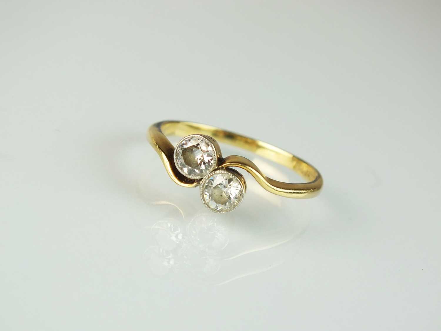 Lot 33 - A two stone diamond crossover ring