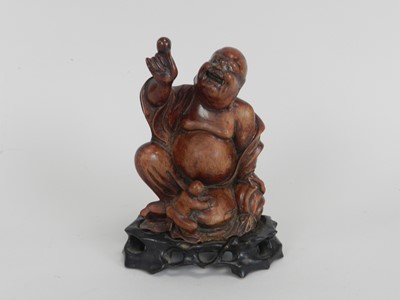 Lot 298 - A Chinese carved hardwood figure of a laughing...