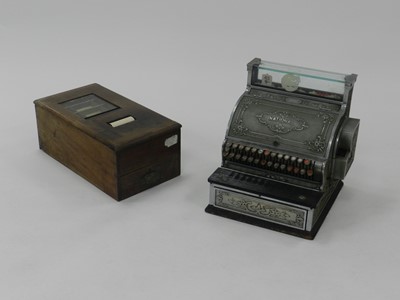 Lot 353 - A National Cash Register embossed metal...