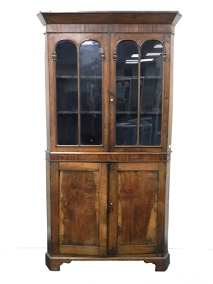 Lot 486 - A 19th century oak and mahogany floor-standing corner cupboard