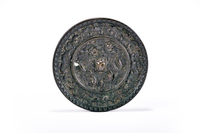 Lot 315 - A Chinese bronze Tang style 'lion and grape' mirror