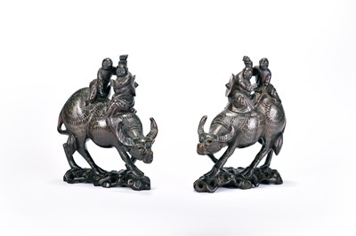 Lot 255 - A pair of Chinese inlaid hardwood figure groups of boys on buffalos