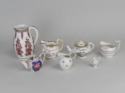 Lot 407 - A group of English teapots, jugs and a miniature French jug