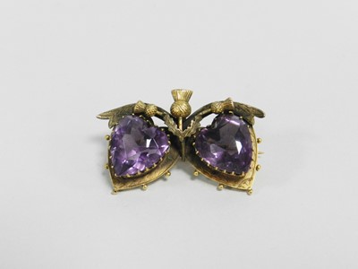 Lot 356 - An amethyst set double heart brooch