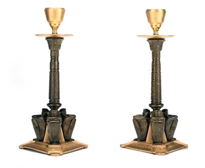 Lot 399 - A pair of French parcel gilt bronze Egyptian revival candlesticks