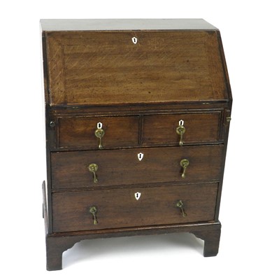 Lot 388 - A small, well proportioned, George III oak bureau