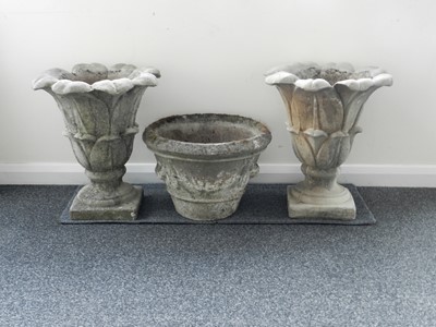 Lot 279 - A pair of Coade-style garden urns, of lotus form and another (3)