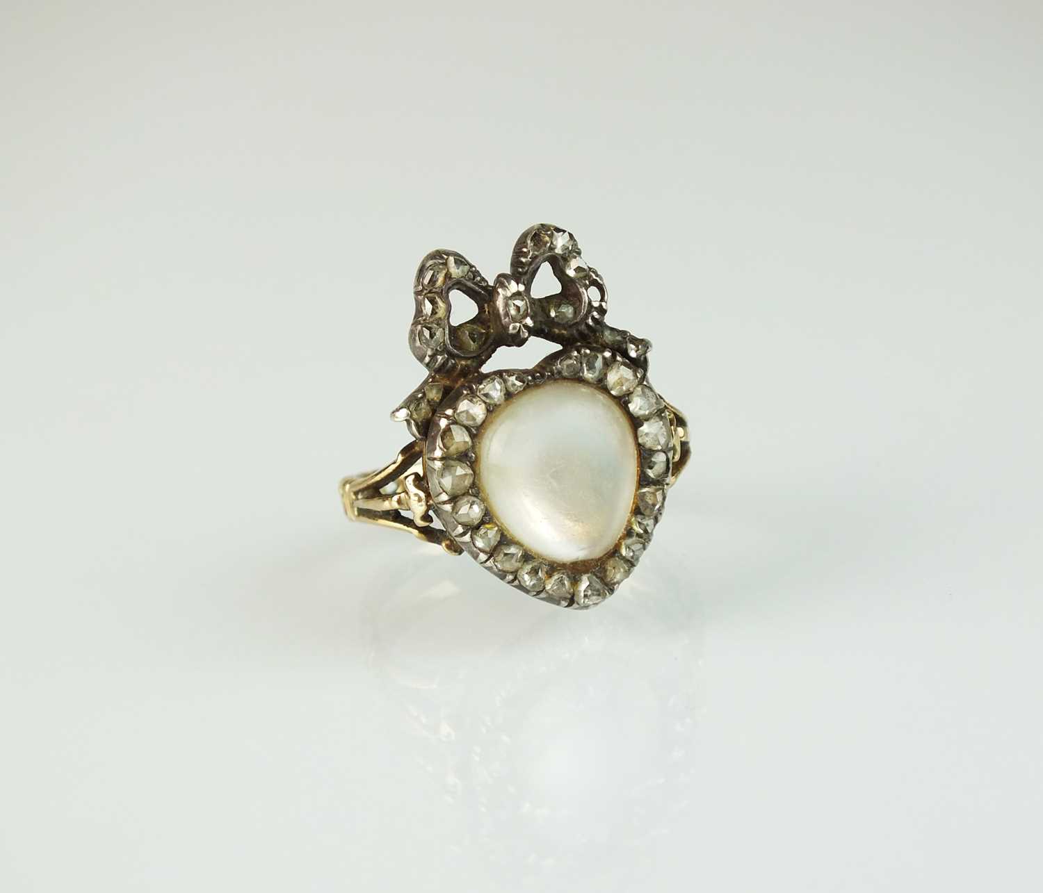 45 - A 19th century moonstone and rose cut diamond heart and bow ring