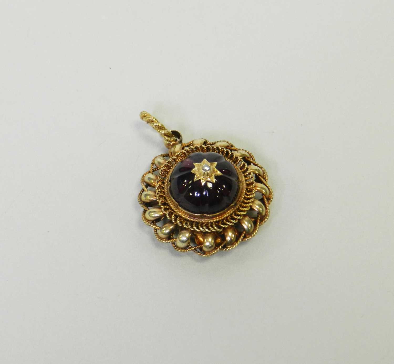 Lot 28 - A Victorian style garnet and diamond locket pendant