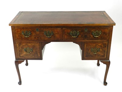 Lot 647 - A 20th century, George II style, walnut veneered writing table, converted from a dressing table