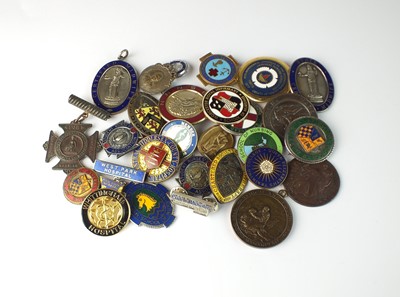 Lot 83 - A collection of base metal and enamelled nursing medals
