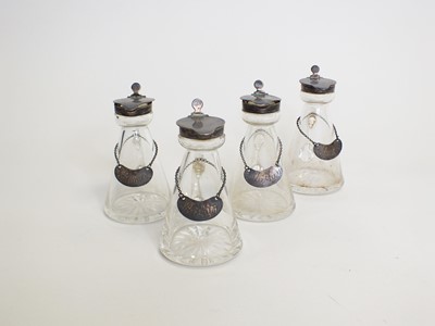 Lot 11 - A set of four silver topped whiskey noggins and labels