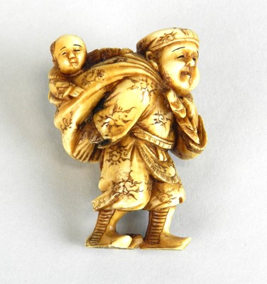 Lot 186 - A Japanese netsuke of a farmer with his son in...