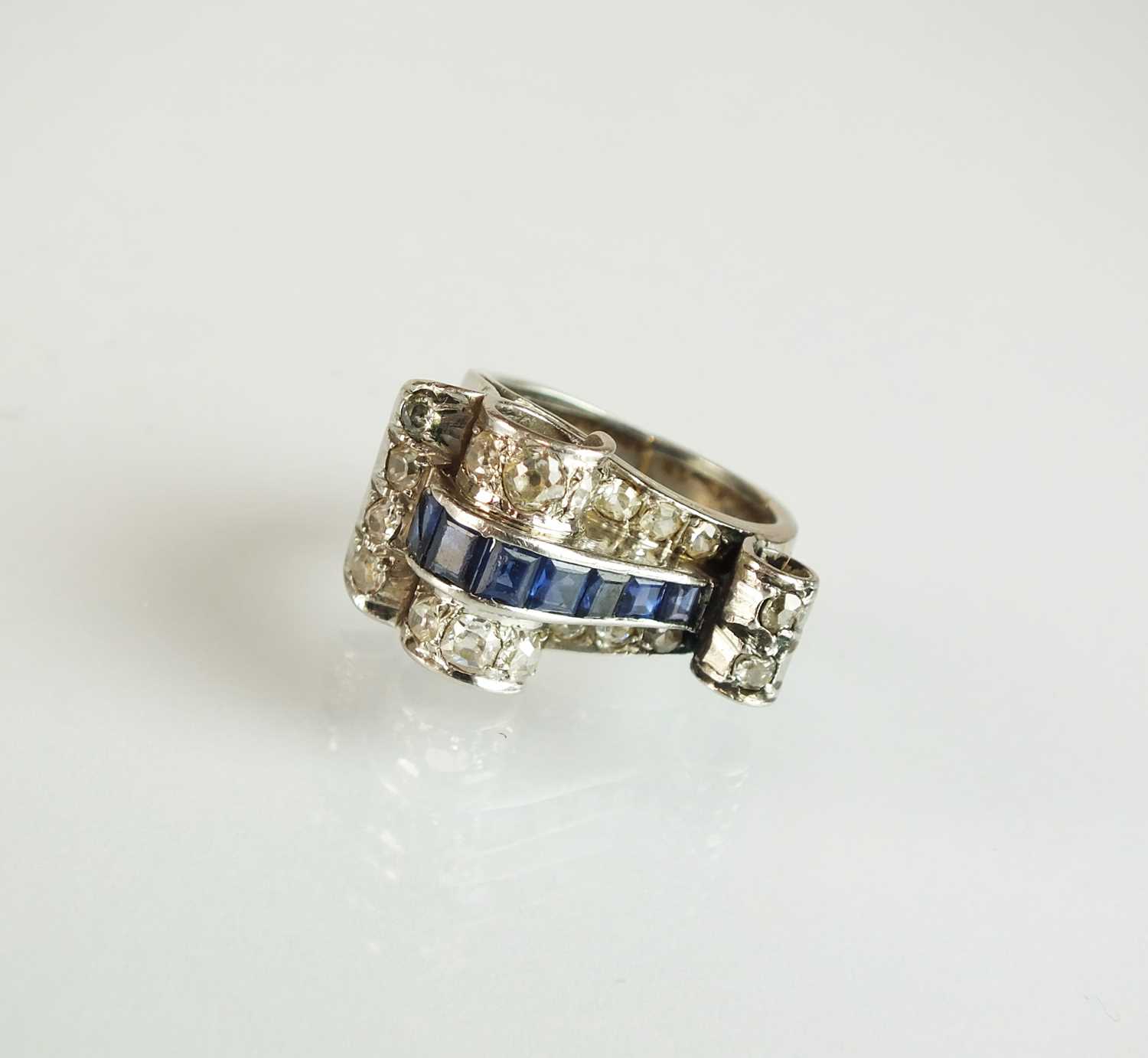 Lot 140 - An Art Deco diamond and sapphire cocktail ring