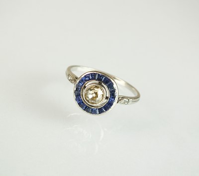Lot 119 - An Art Deco diamond and sapphire target ring,...